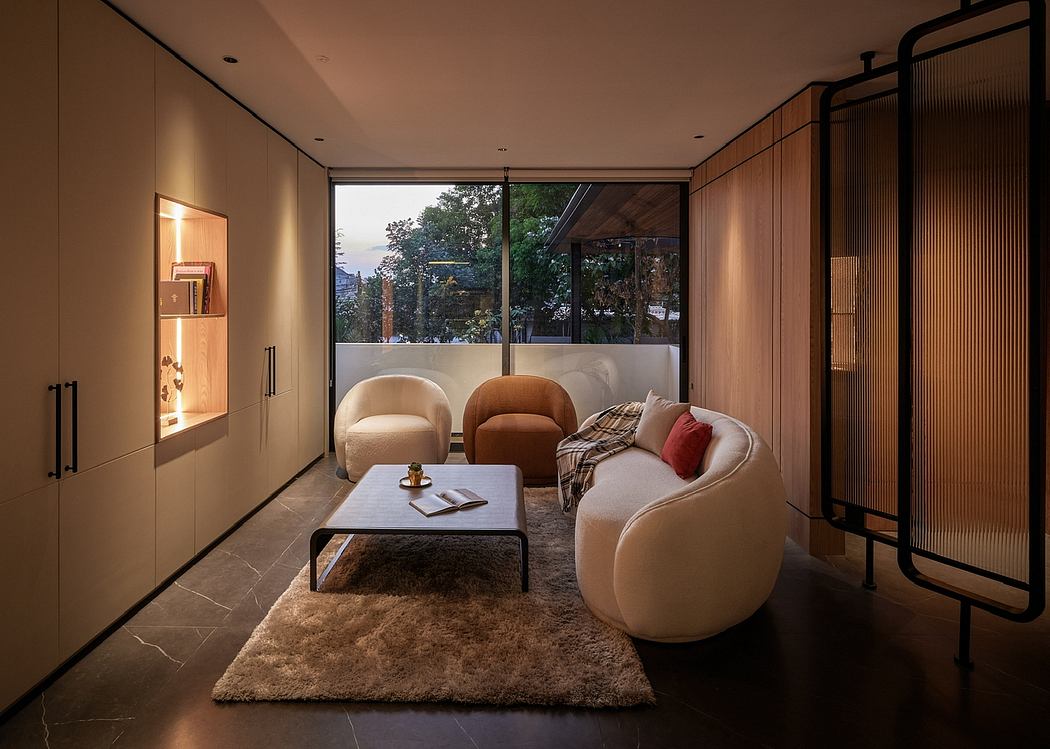 Warm, modern living space with plush seating, wooden accents, and floor-to-ceiling windows.