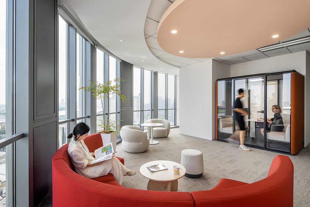 Spacious, modern office with curved ceiling, abundant natural light, and comfortable seating.