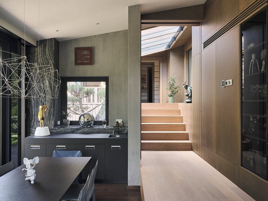 Modern interior with wooden stairs, sleek cabinets, and artistic decor elements.