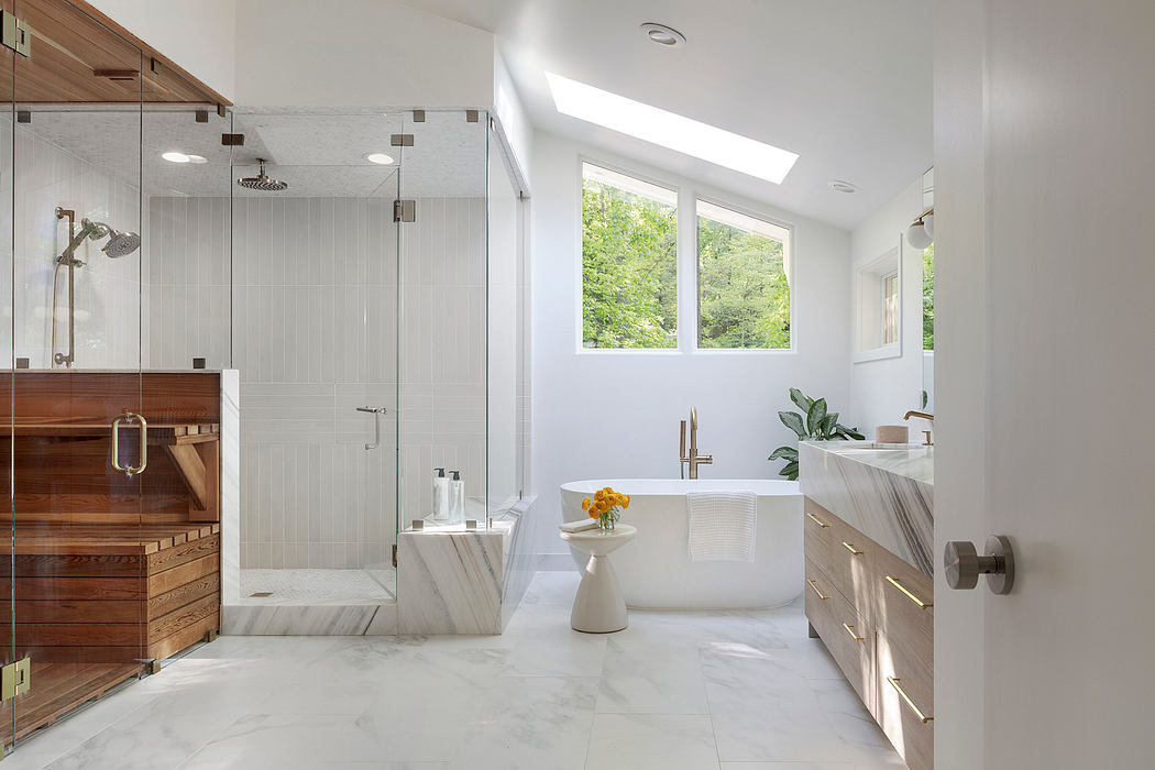 A spacious, modern bathroom with a freestanding tub, glass shower, and wood cabinetry.