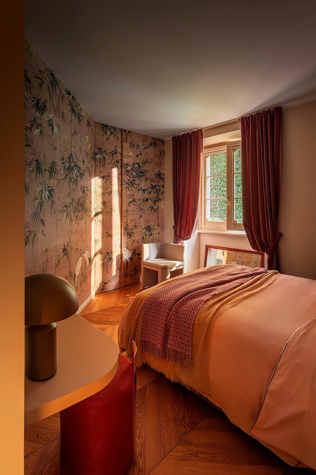 Cozy bedroom with bamboo-patterned walls, plush bedding, and floor-to-ceiling windows.