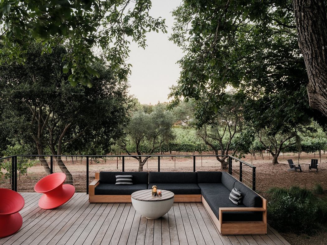 Tranquil outdoor deck with modern modular furniture, surrounded by lush greenery.