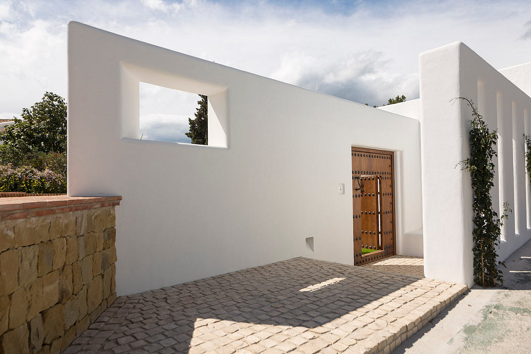 Striking modern architecture with textured stone, geometric forms, and a wooden entrance.