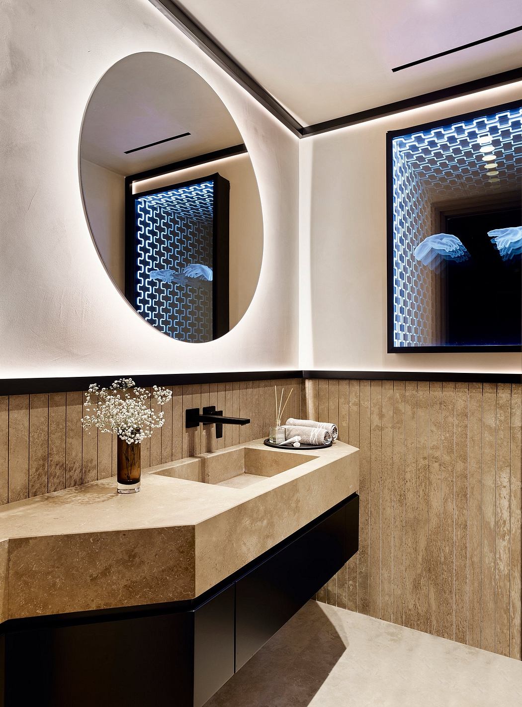 Elegant bathroom design featuring a circular mirror, textured walls, and a minimalist vanity.