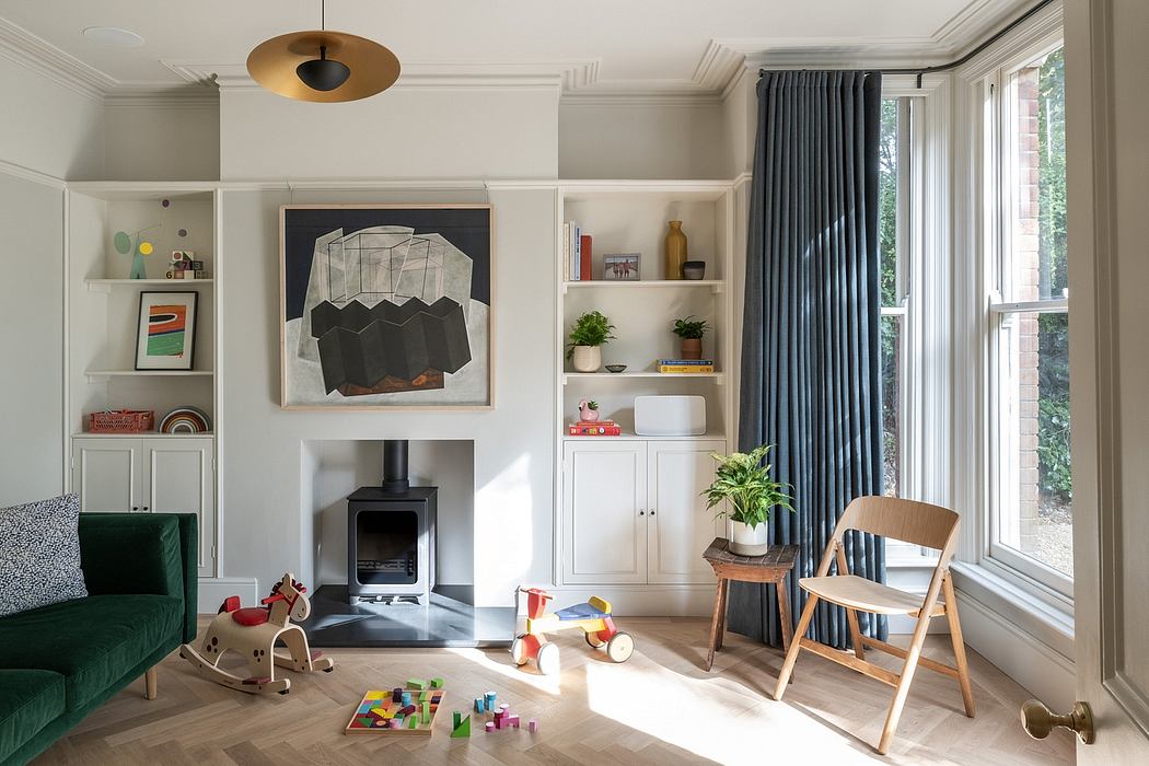 Cozy living room with minimalist decor, built-in shelves, and a central fireplace.