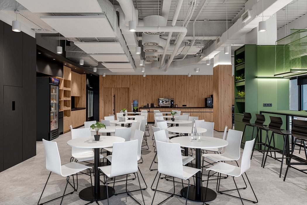 An airy, modern office space with wooden walls, white tables and chairs, and industrial-style lighting.