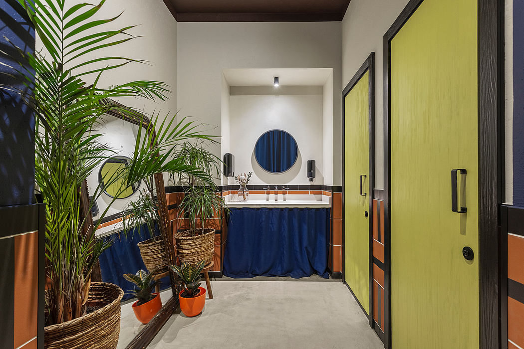 Tropical-inspired bathroom with vibrant blue and yellow accents, lush greenery, and modern fixtures.