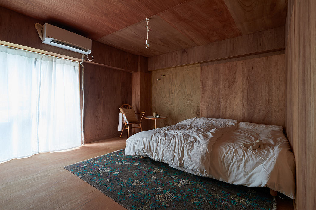 Cozy wooden cabin interior with plush bedding, wall-mounted AC unit, and patterned rug.