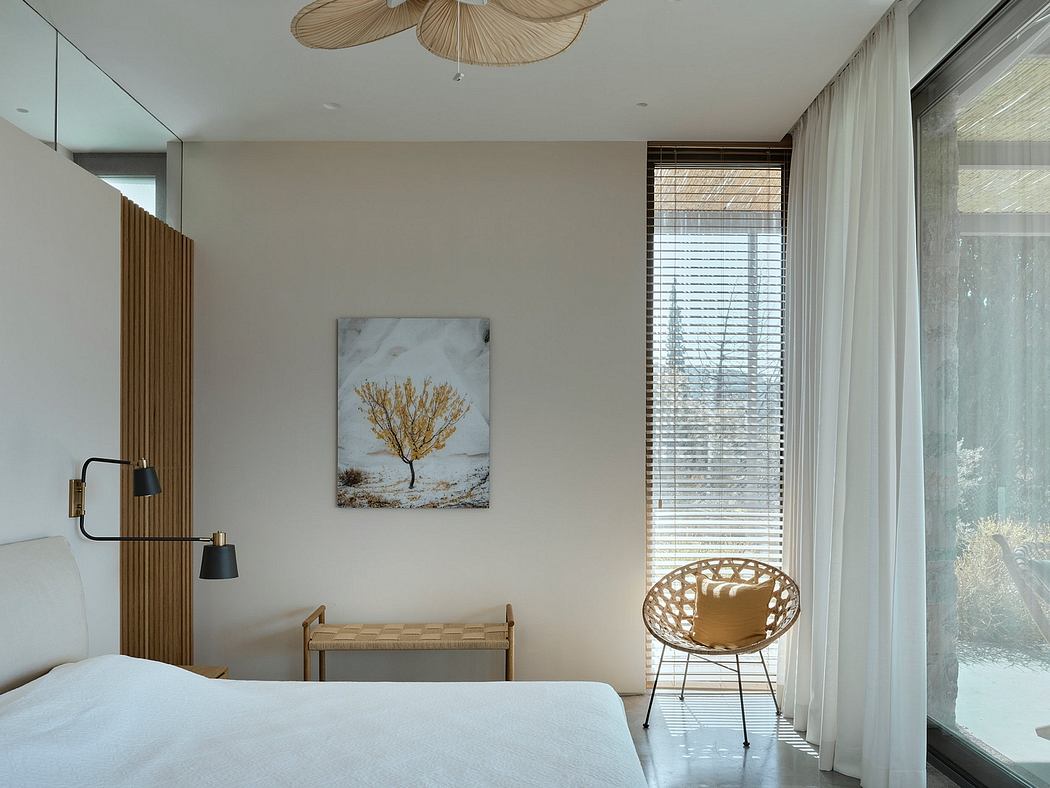 Minimalist bedroom with wood accents, natural lighting, and a statement artwork.