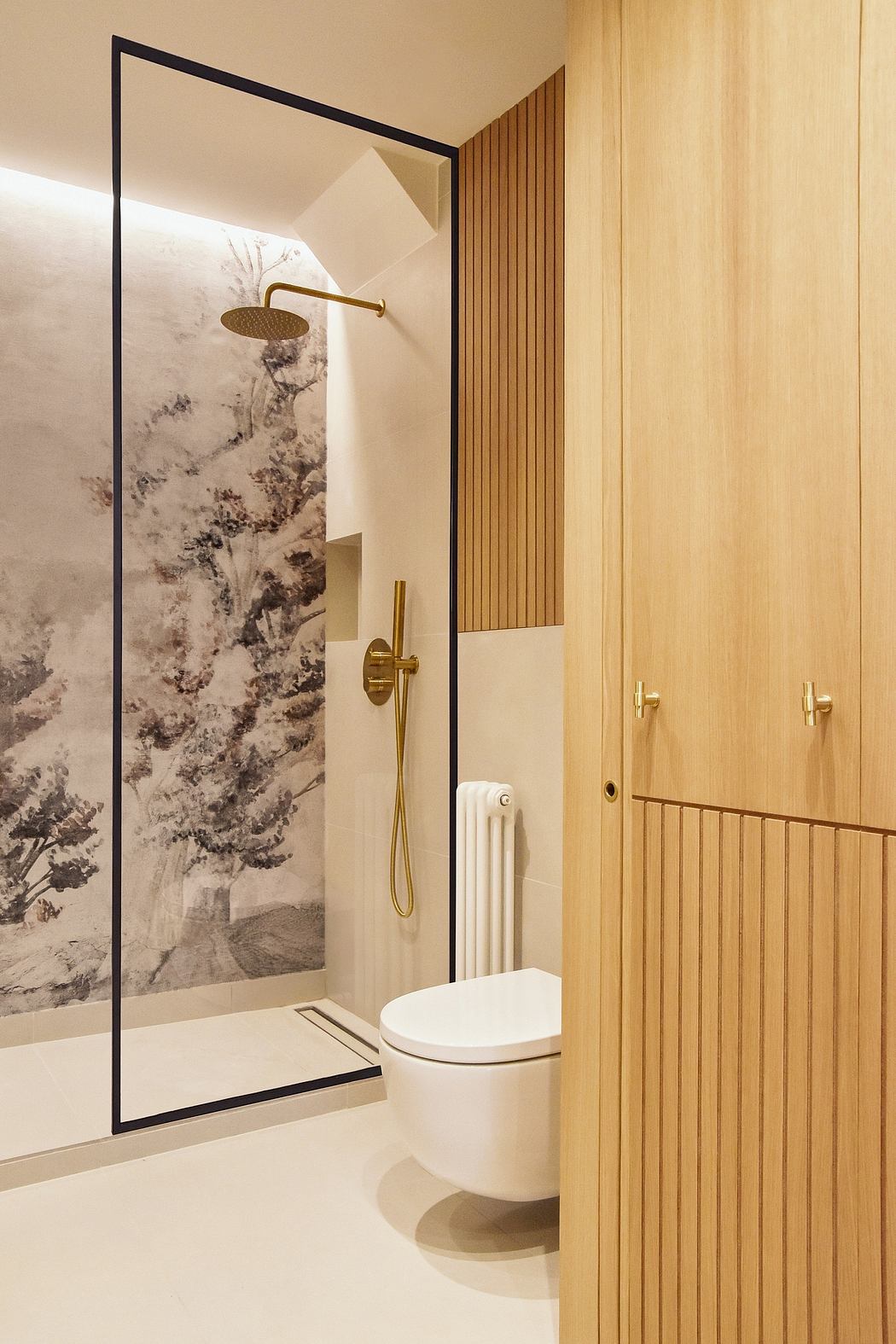 A modern bathroom with a marble-patterned shower enclosure, gold fixtures, and wooden paneling.