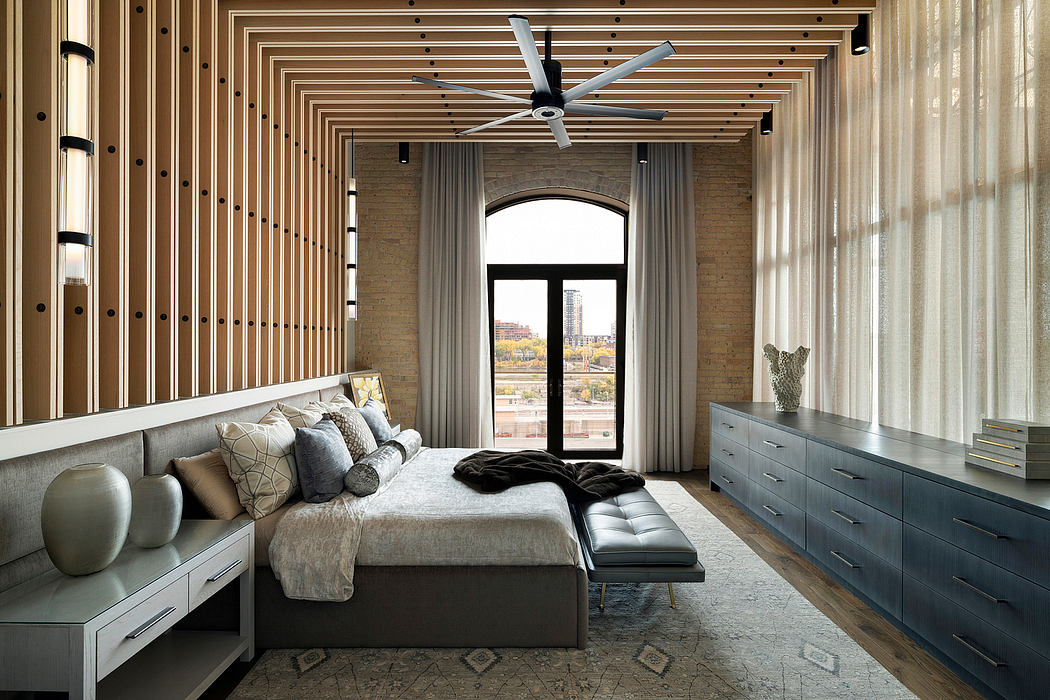 Spacious bedroom with wooden ceiling beams, arched window, and modern furnishings.