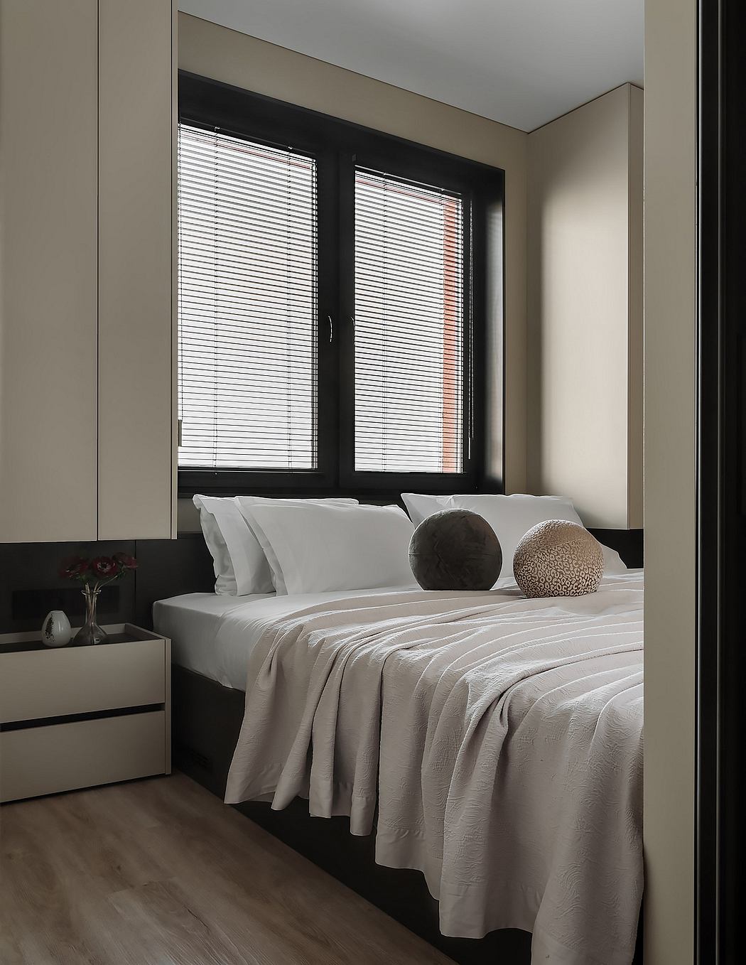 Minimalist bedroom design with neutral tones, sleek window blinds, and textured decor.