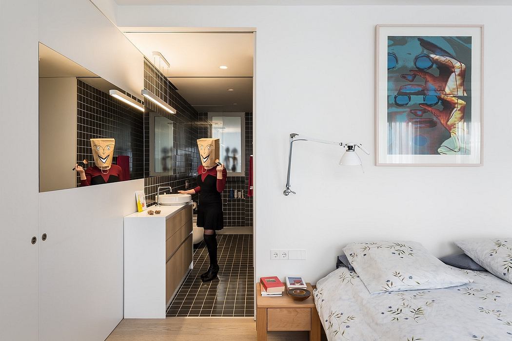 Modern bathroom with sleek tiling, art piece adds visual interest, cozy bedroom space.