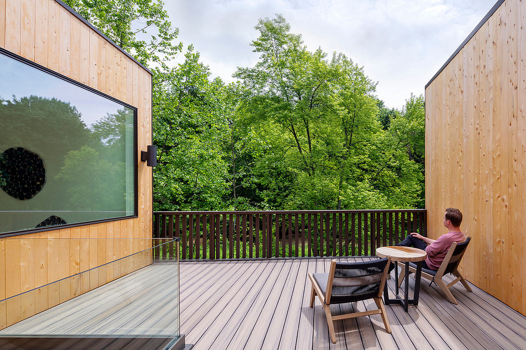 Wooden exterior with expansive deck and scenic forest view, modern architectural design.