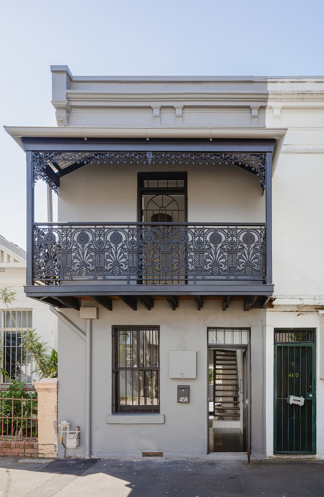 Ornate iron balcony and architectural details of a historic building facade.
