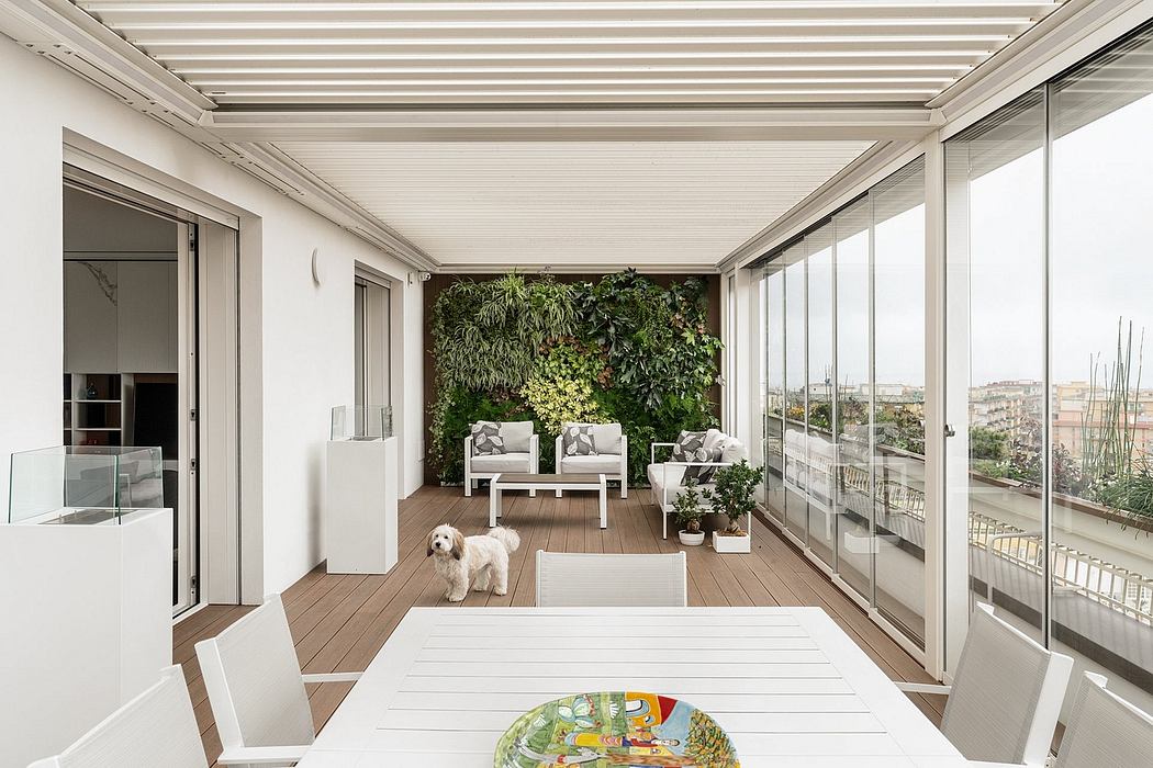 A bright and modern balcony with lush vertical garden, large windows, and cozy seating.