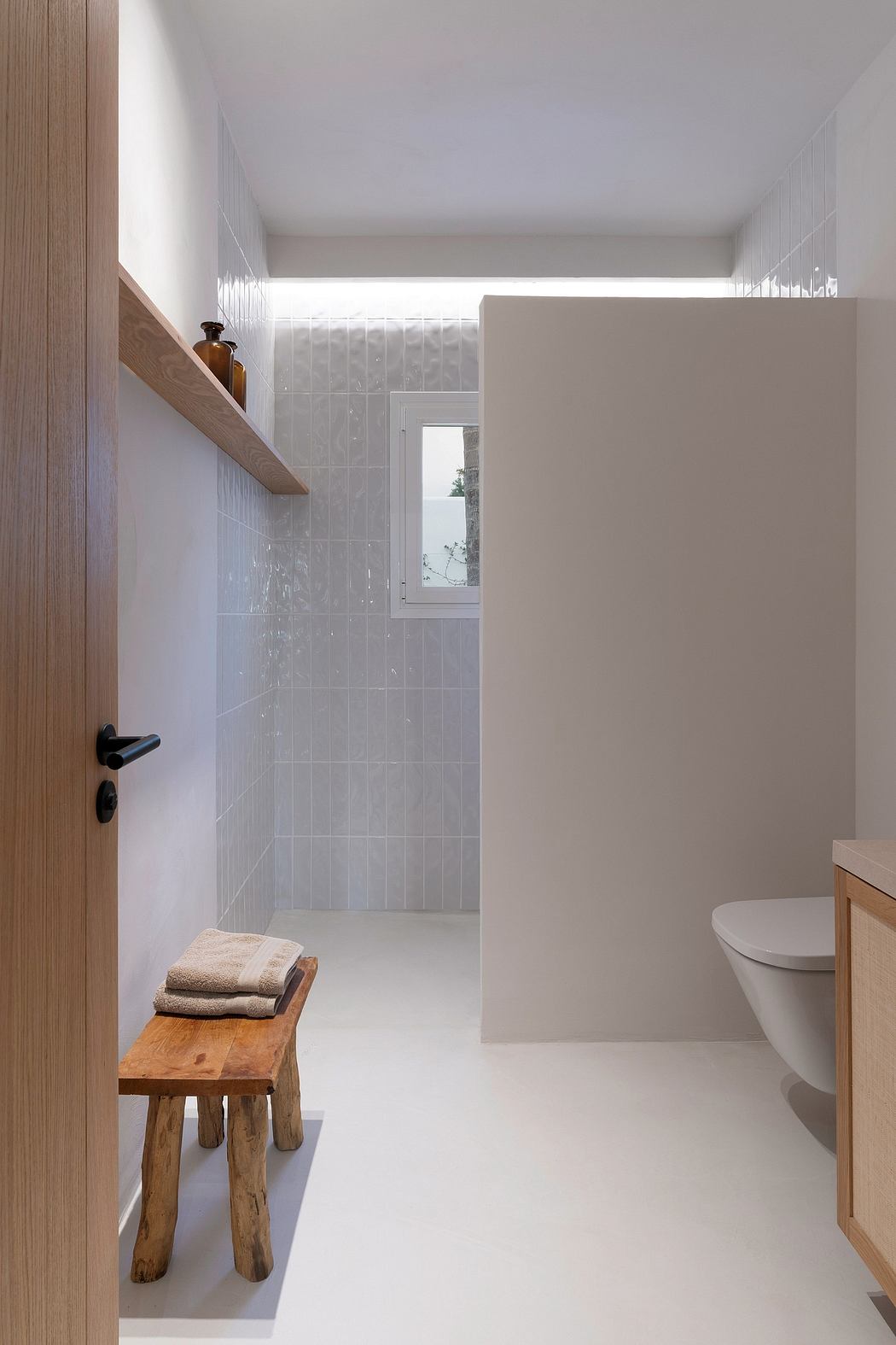 Minimalist bathroom with wood accents, tiled walls, and simple vanity design.
