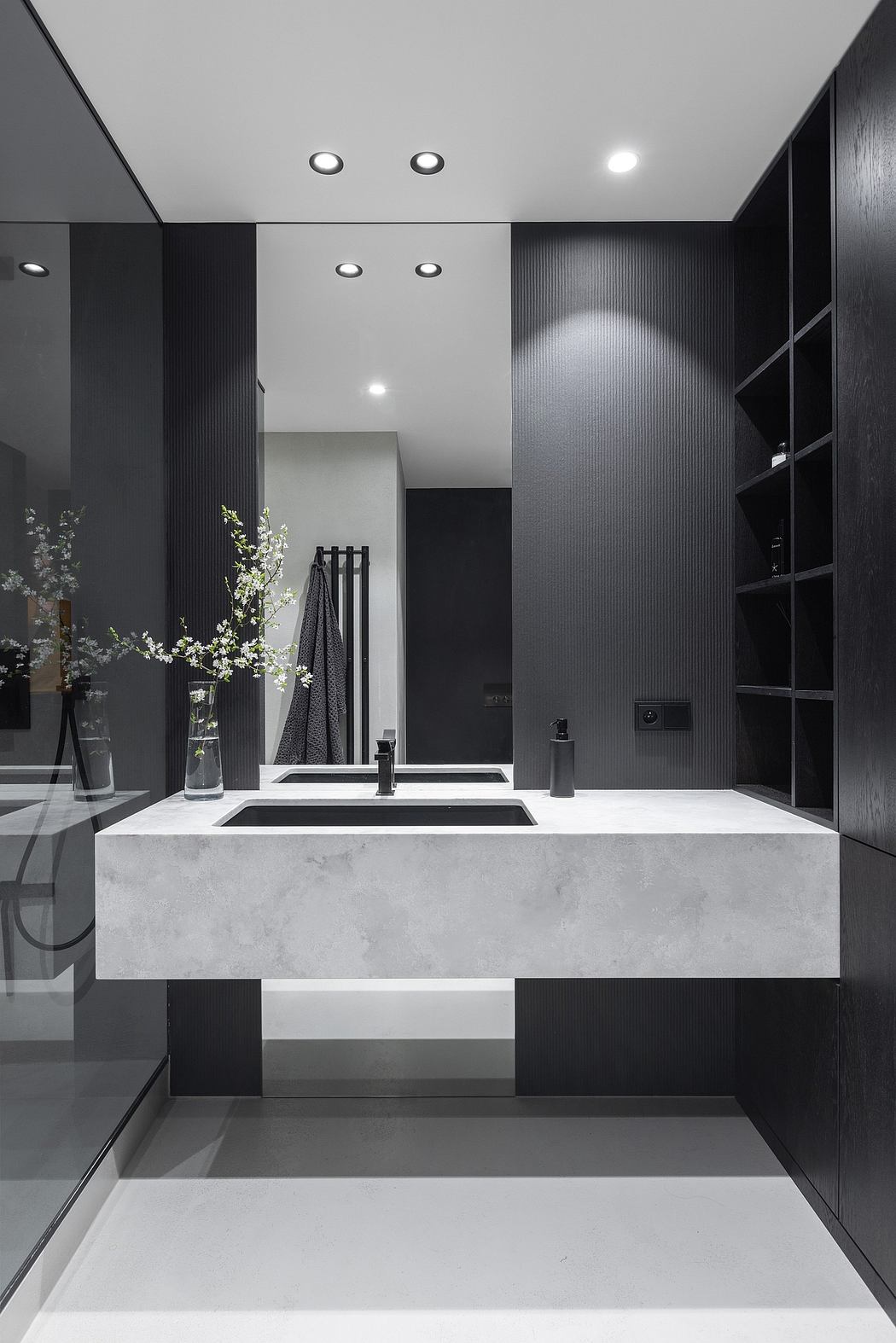 Sleek, modern bathroom with monochrome color scheme, minimalist design, and integrated lighting.