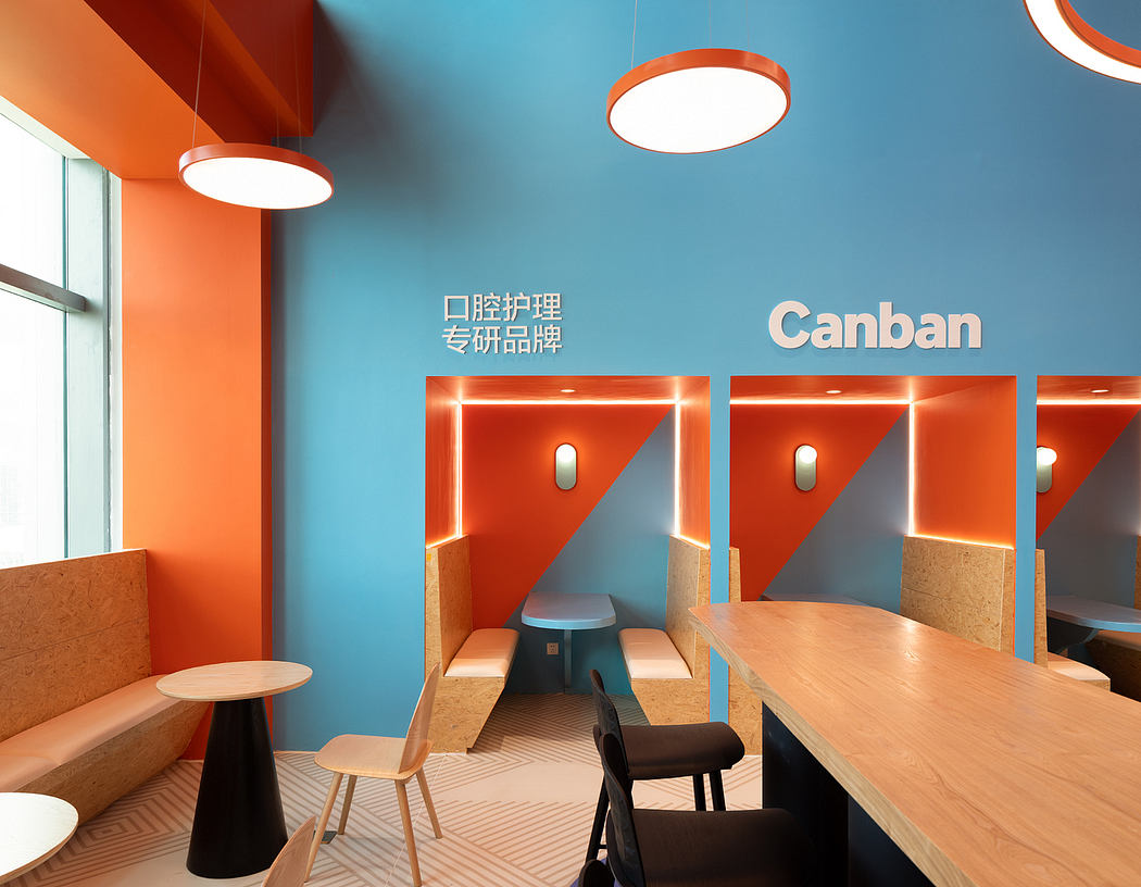 Vibrant orange accents, sleek wooden furniture, and modern lighting create an inviting office space.