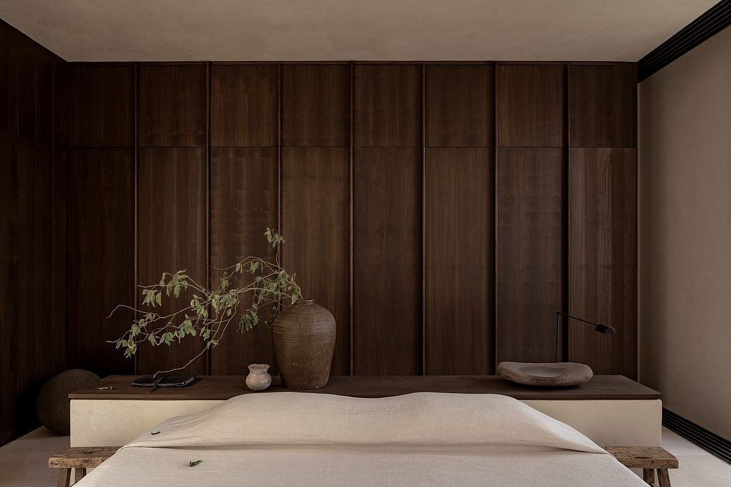 Minimalist Japanese-inspired bedroom with wooden paneling, natural elements.