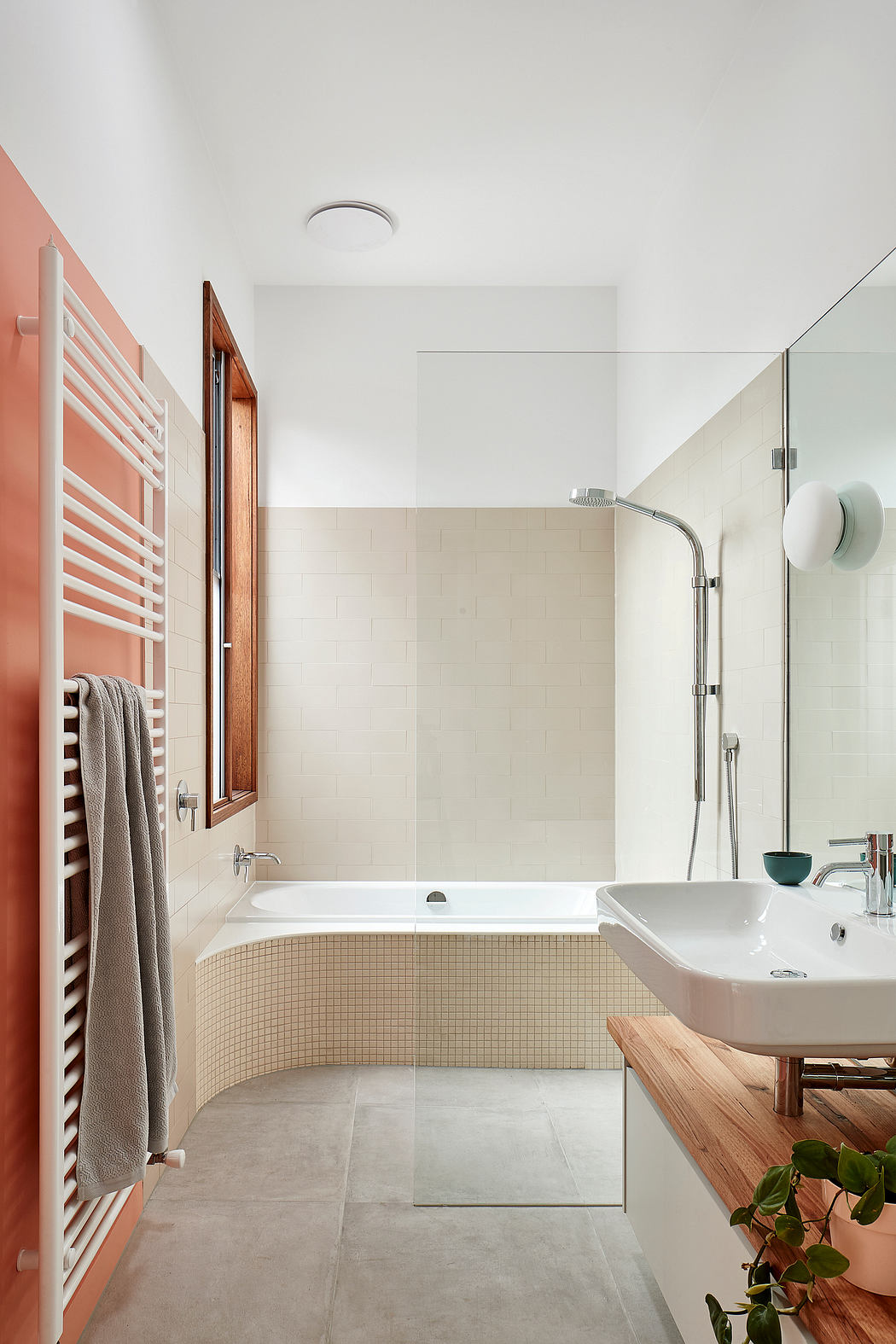 Well-designed bathroom with modern fixtures, textured tiling, and warm wood accents.