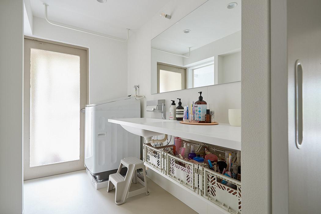 Modern and minimalist bathroom with sleek vanity, storage crates, and natural lighting.