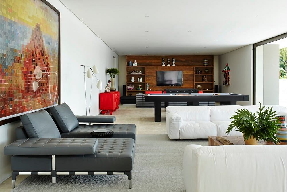 Vibrant modern living room with sleek furniture, artwork, and built-in entertainment unit.