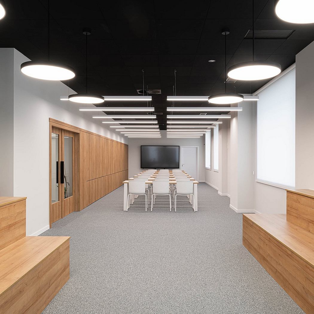 Sleek, minimalist office space with wooden panels, pendant lighting, and modular seating.