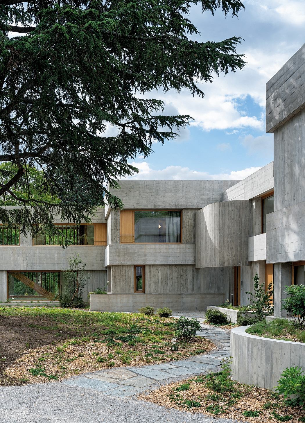 An architectural masterpiece blending concrete, wood, and lush greenery in a harmonious design.