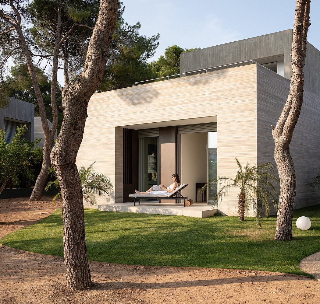 A modern, minimalist architectural design featuring a sleek exterior and a lush, well-manicured landscape.