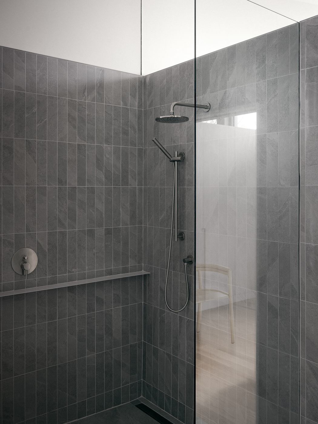 Minimalist gray tile shower with sleek fixtures and a glimpse of an adjacent room.