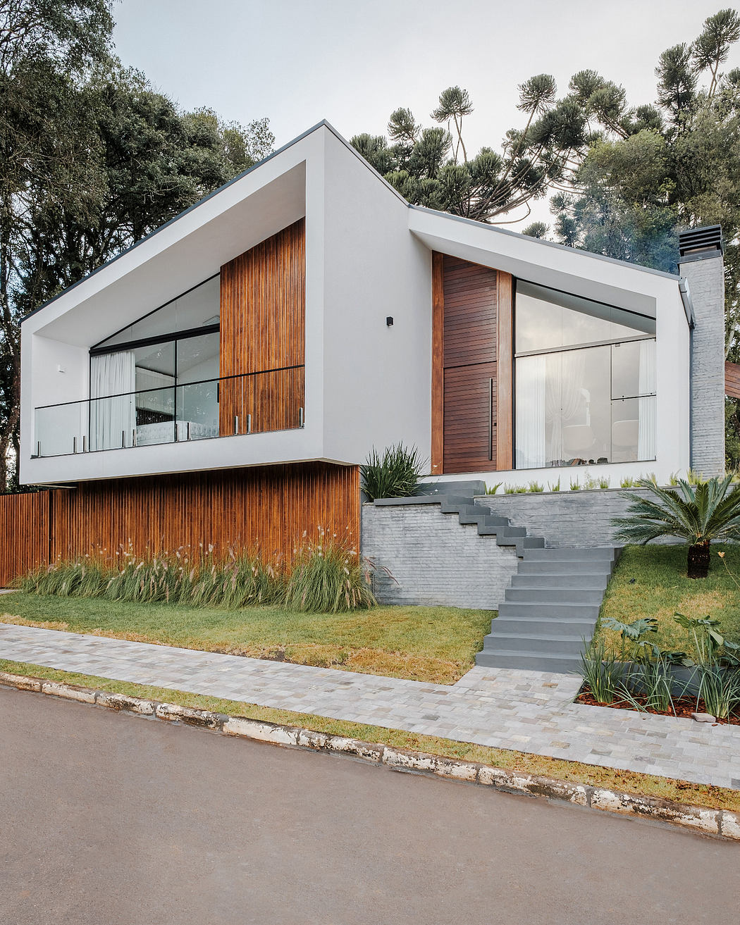 A modern, minimalist house with sleek lines, warm wood accents, and a clean exterior.