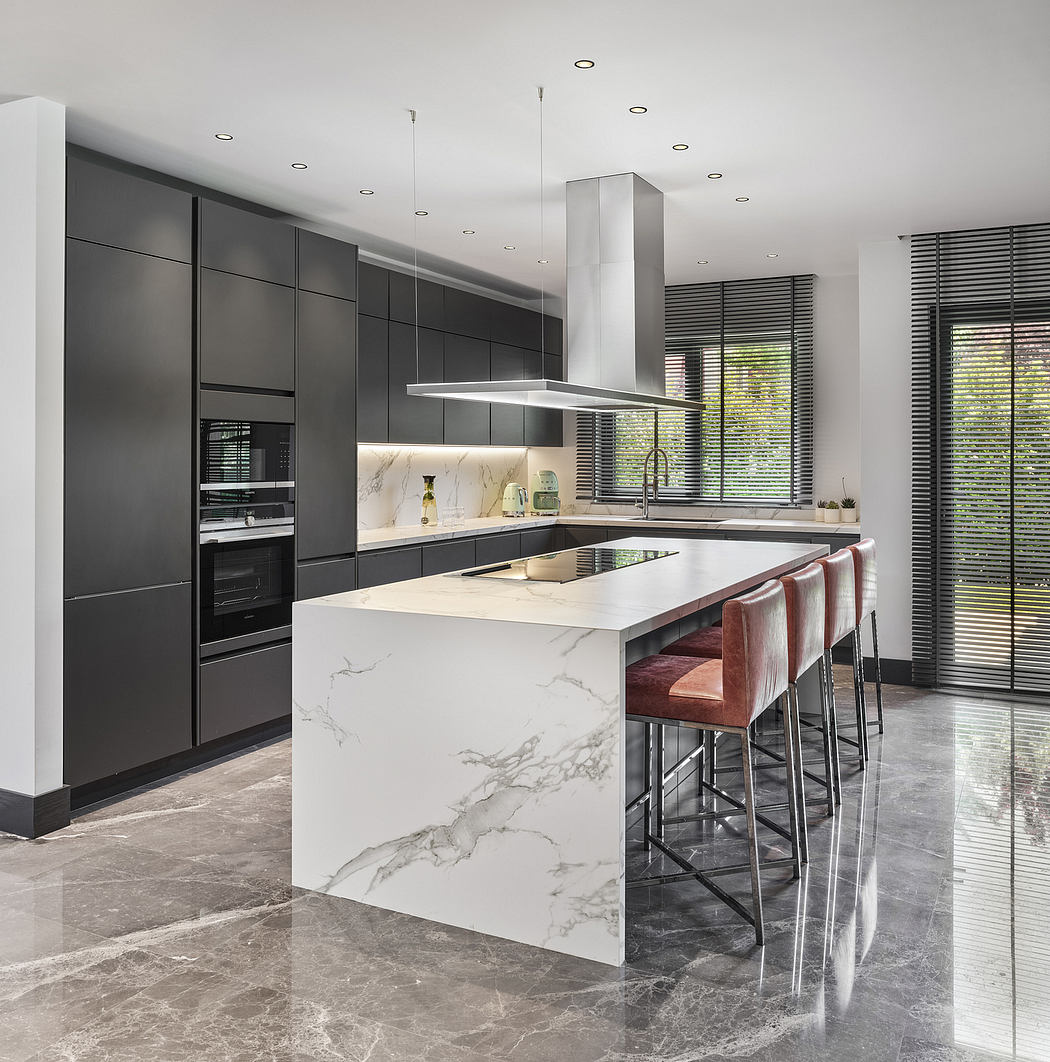 Elegant modern kitchen with sleek grey cabinetry, marble countertop, and stylish pendant lights.