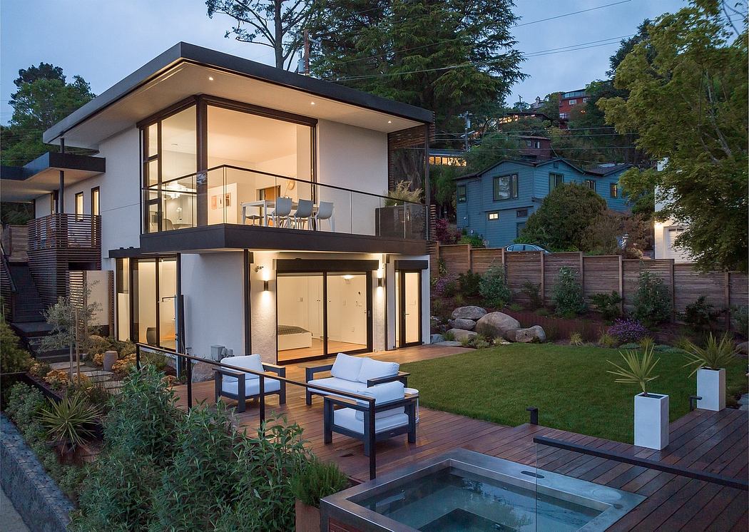Modern two-story home with clean, angular design, large windows, and an inviting outdoor living space.
