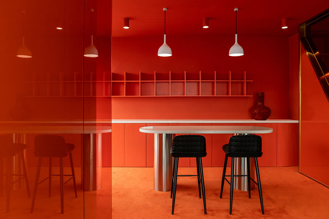 Vibrant red-toned interior design with round dining table, bar stools, and recessed lighting.
