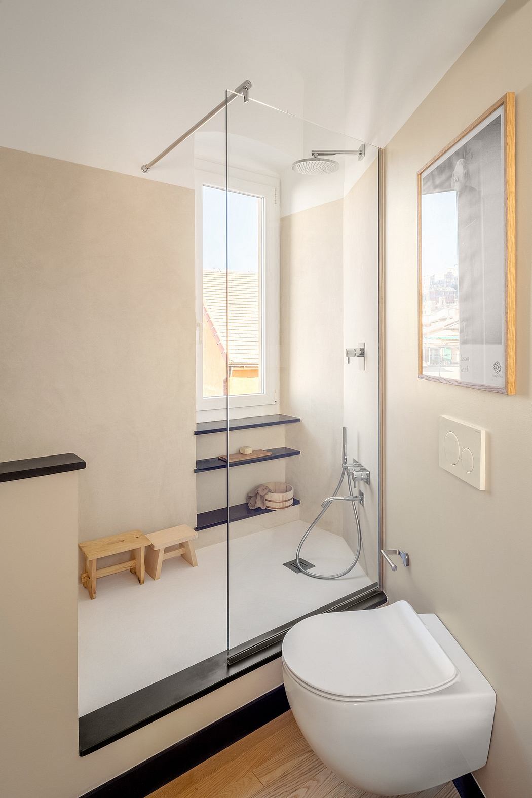 A modern, minimalist bathroom with a glass shower enclosure, shelving, and a white toilet.