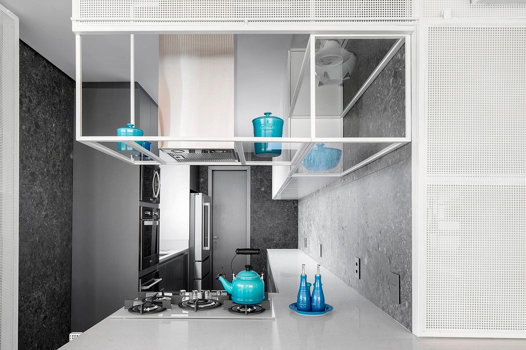 Sleek, minimalist kitchen design with modern appliances and turquoise accents.