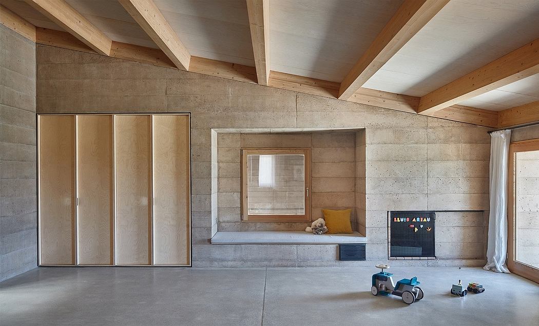 An airy, modern space with exposed concrete walls, wood beams, and built-in cabinetry.