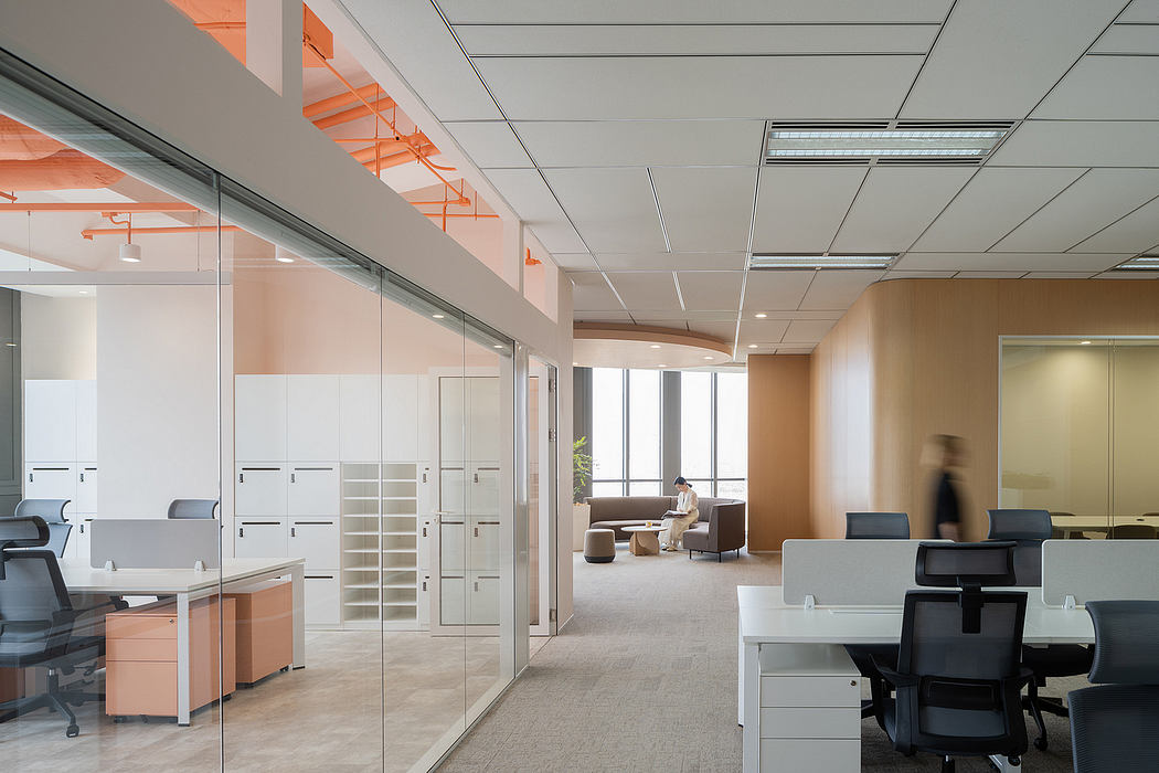 Open-concept office space with glass walls, warm wood tones, and modern furniture.