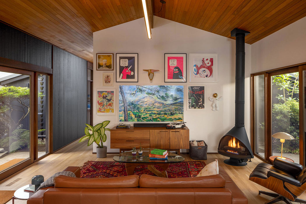 Cozy midcentury living room with wood-paneled ceiling, fireplace, and eclectic decor.