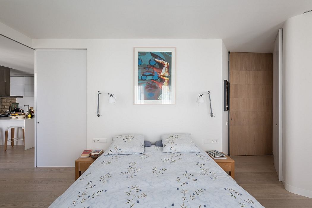 Minimalist bedroom with abstract wall art, floor-to-ceiling windows, and wooden accents.