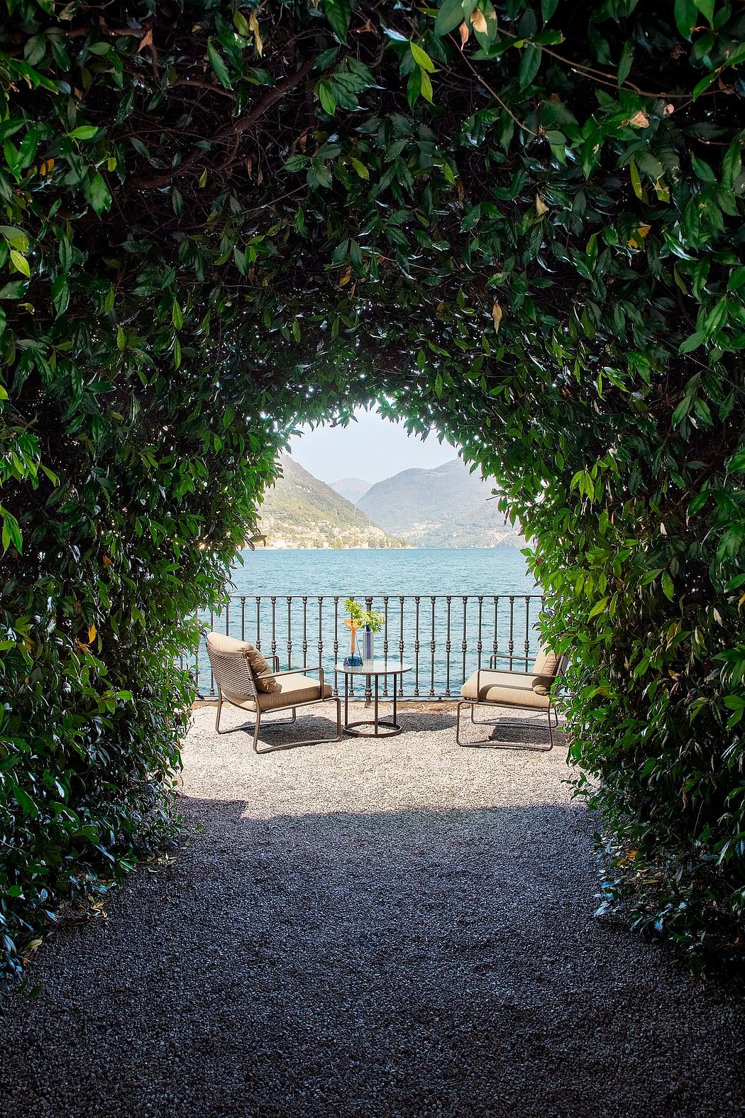 A serene balcony overlooking a tranquil lake, framed by lush greenery and rustic furnishings.