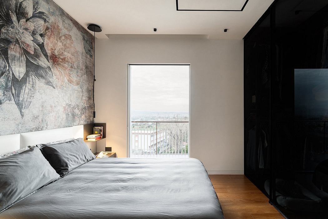 Minimalist bedroom with large window showcasing cityscape, abstract mural, and modern furnishings.