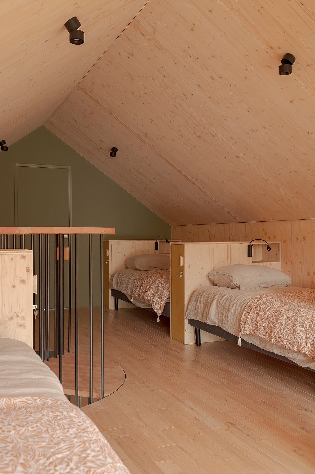 Cozy attic bedroom with wooden walls, sloped ceiling, and modern bunk beds.