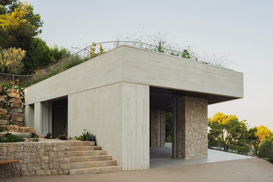 A modern, minimalist stone and concrete structure with a clean, architectural design.