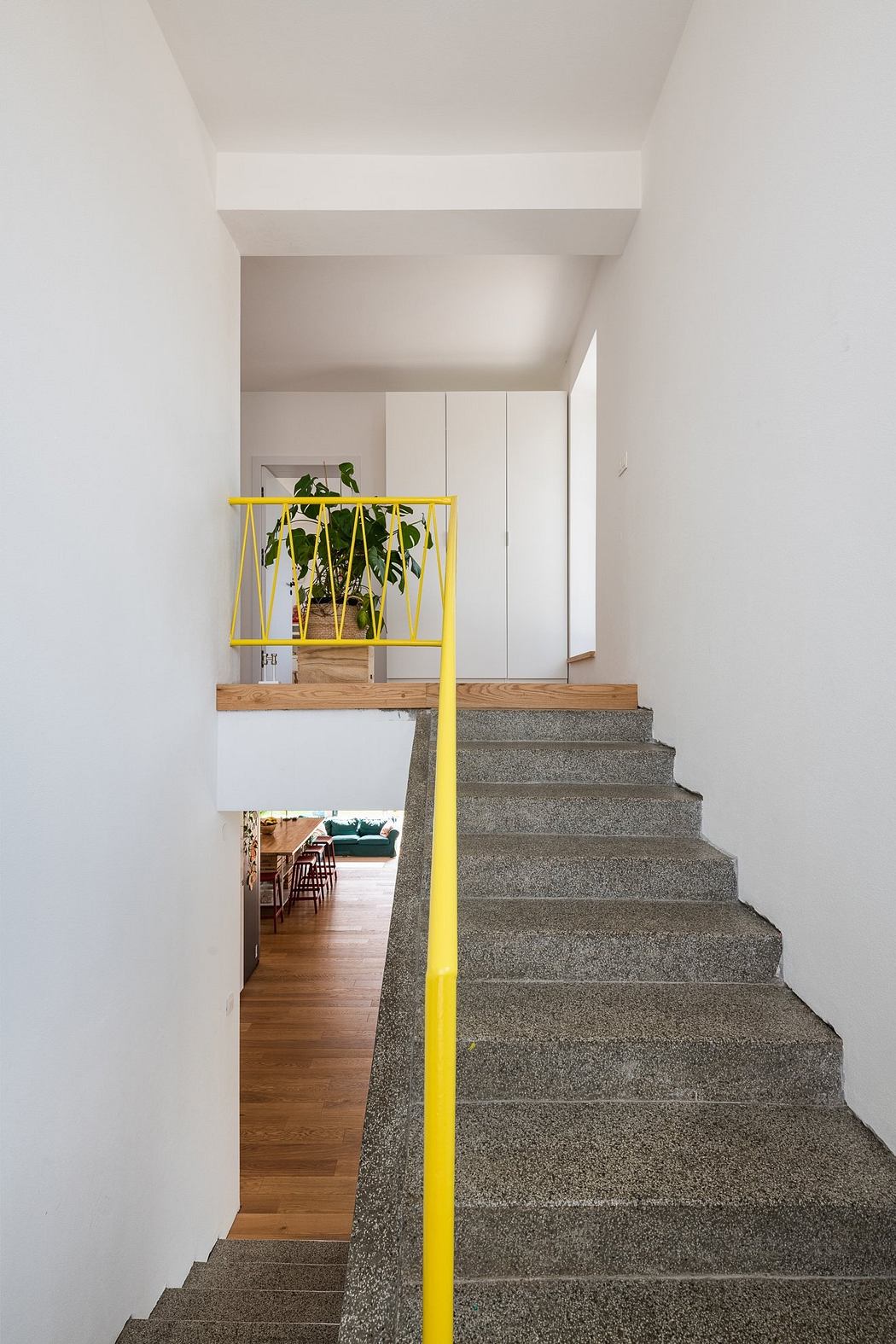 Modern stairs with yellow accent in minimalist interior design.