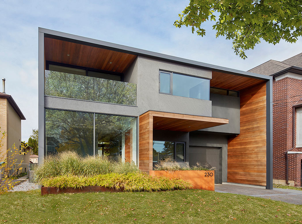 Contemporary two-story house with sleek architectural design, wooden accents, and lush landscaping.
