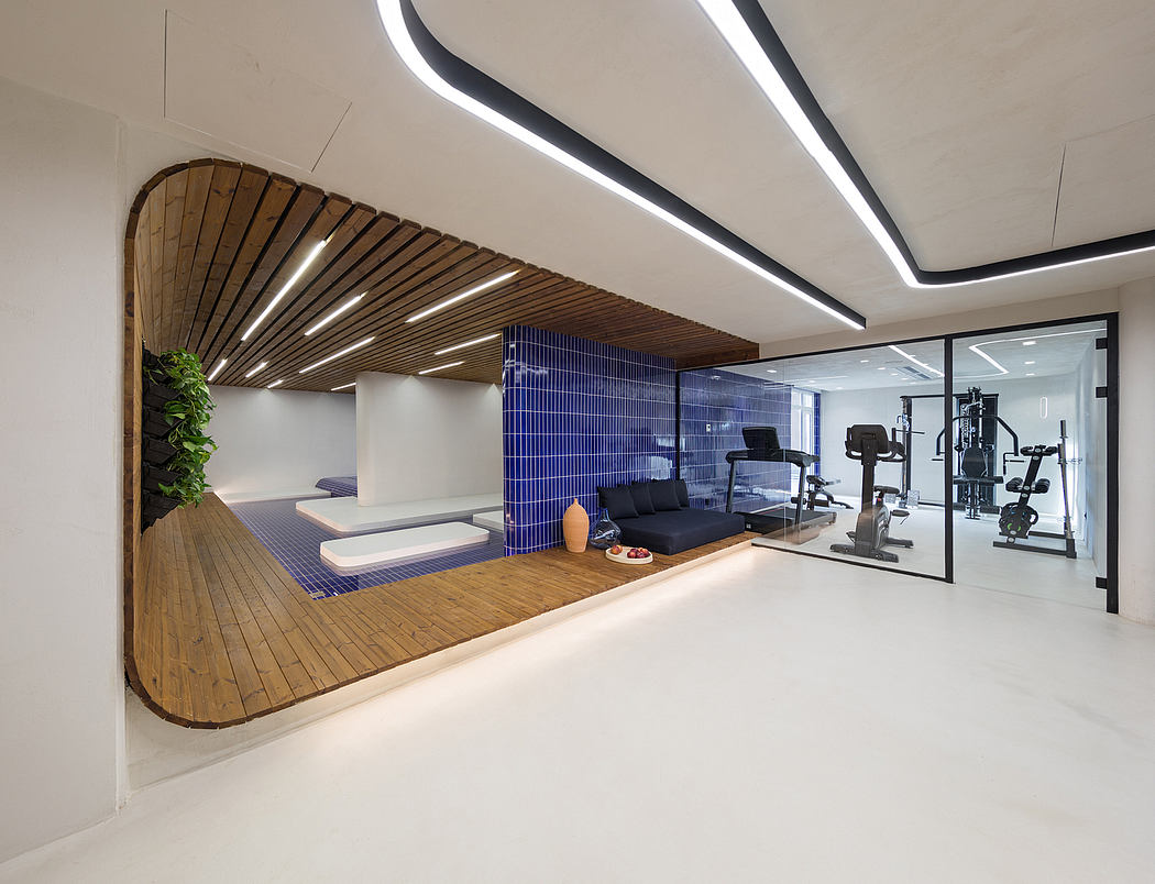 Sleek, modern gym interior with curved wooden ceiling panels, blue tiles, and workout equipment.