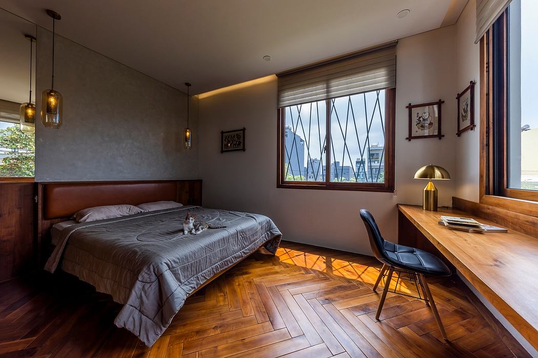 A cozy bedroom with warm lighting, wooden floors, and a modern desk overlooking the city.