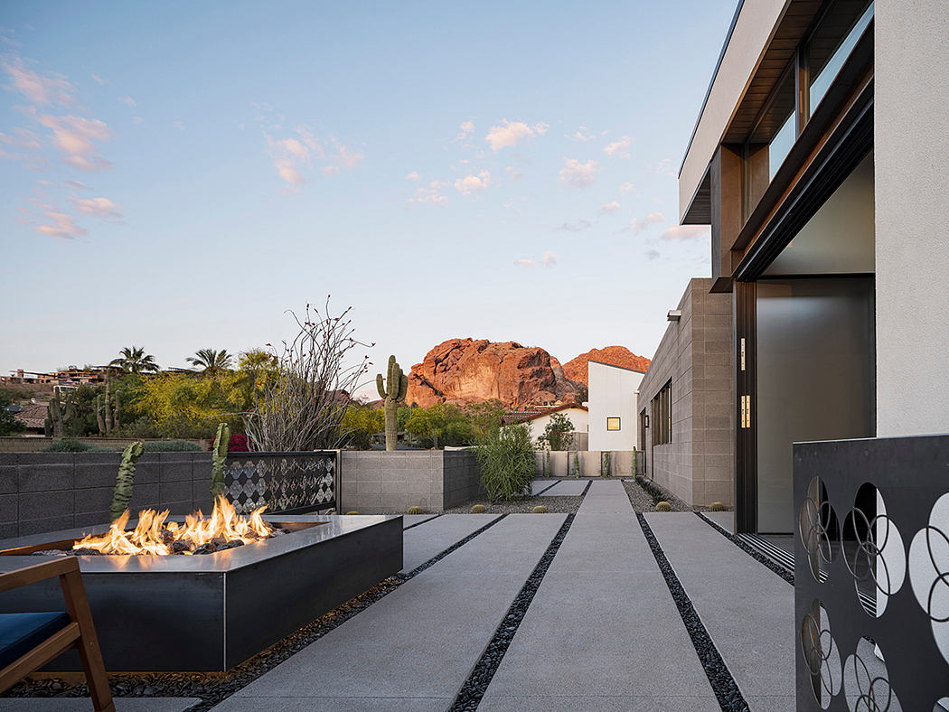 Striking desert-inspired architecture with a modern fire feature and sculptural elements.